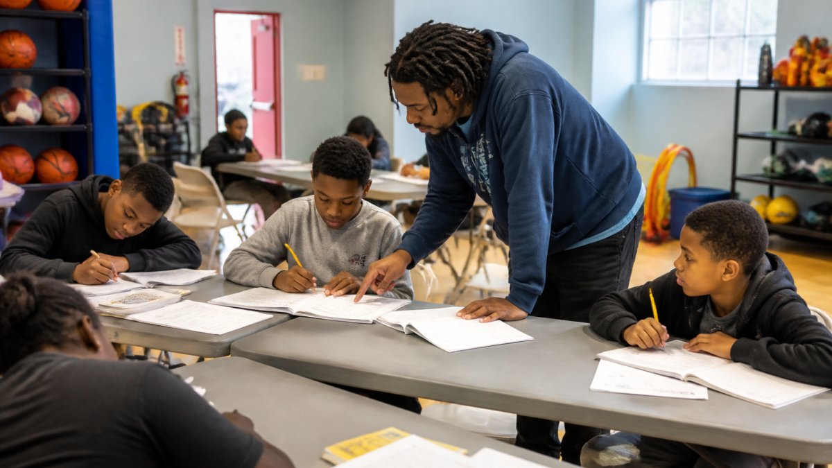 Mentor helping students with homework during after school activities in Edgewood DC at the community center